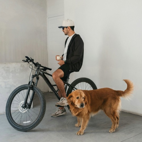 a man on a bike with his dog