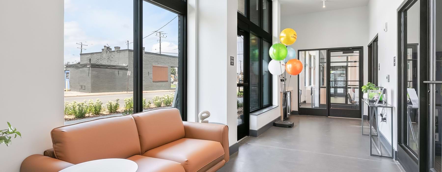 office with couch and a view of the street outside